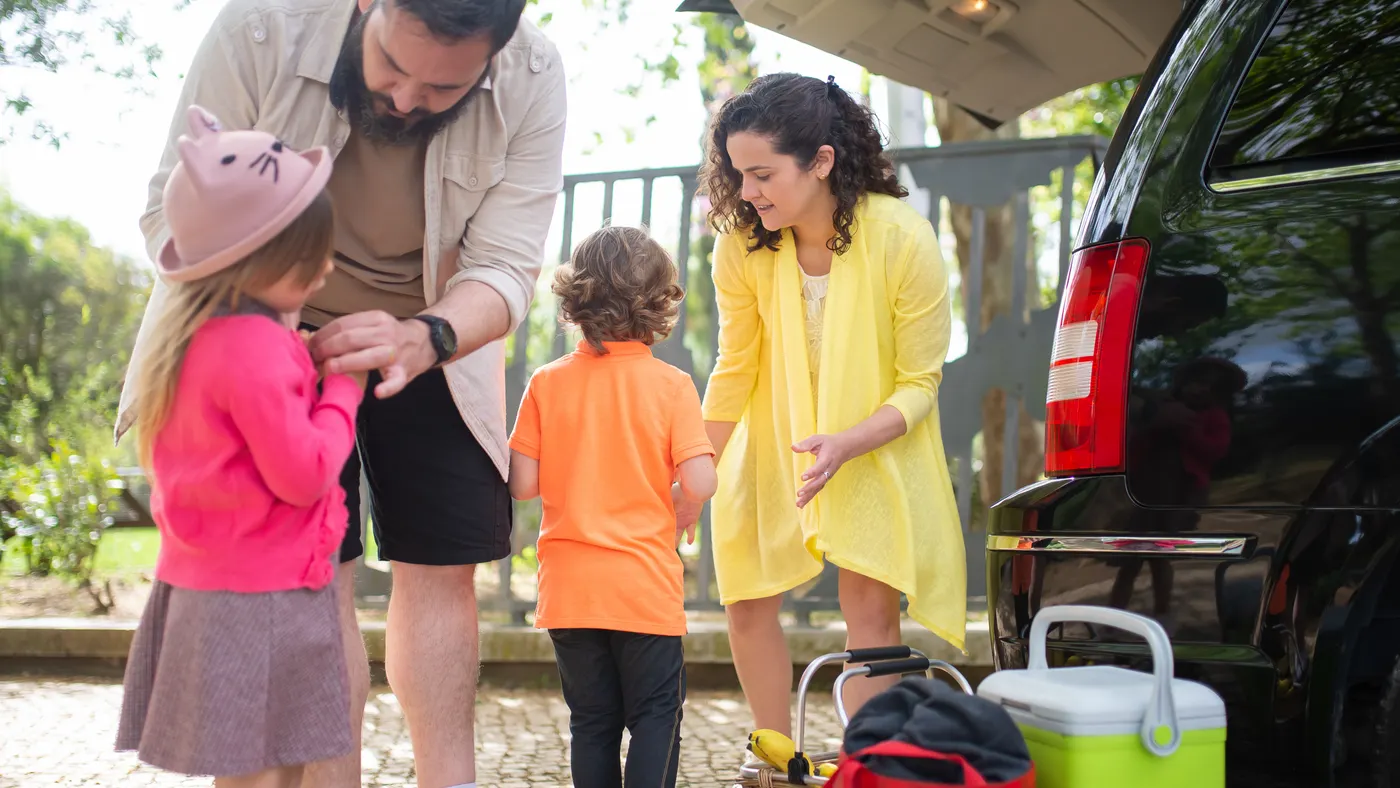 Family preparing for a rental-car road trip