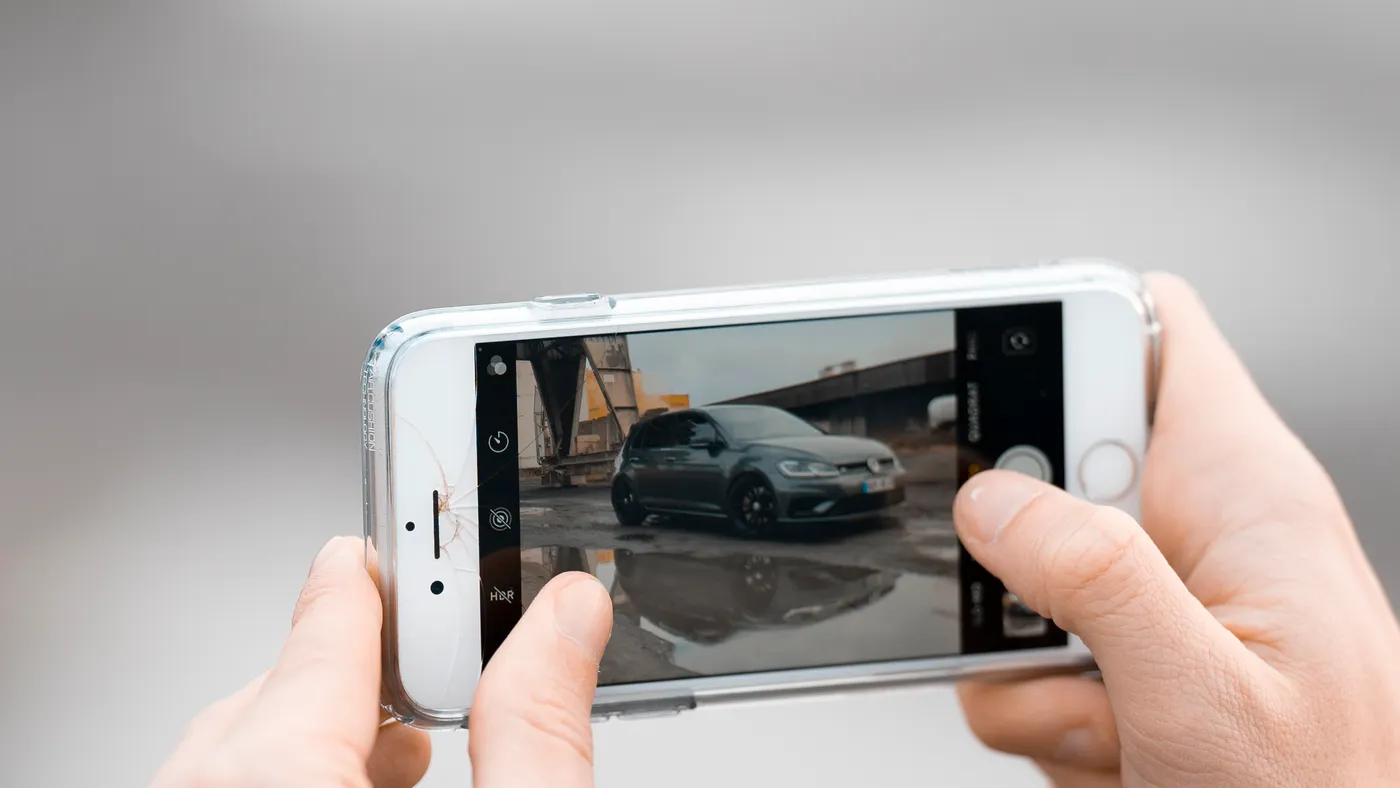 Photographing a hire car exterior during the collection condition check
